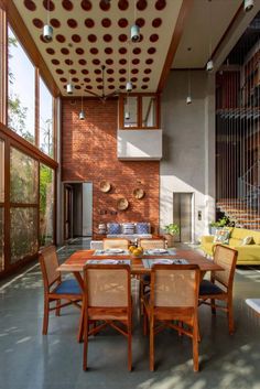 a dining room table with chairs and a couch in front of an open floor plan