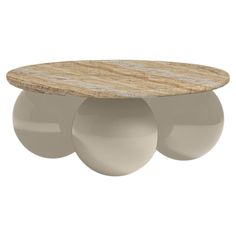 an oval coffee table with three balls on the top and one ball at the bottom