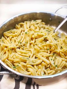 a pan filled with pasta on top of a table