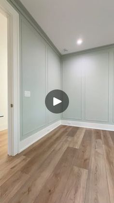 an empty room with wood floors and white walls