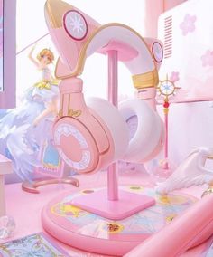 there is a pink toy with headphones on top of the stand in the room