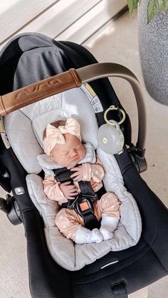 a baby in a car seat on the ground