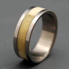 a wedding ring with two wood inlays on the outside and an inner band