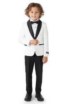 a little boy in a tuxedo and bow tie