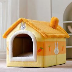 a yellow dog house with bunny ears and carrots on it