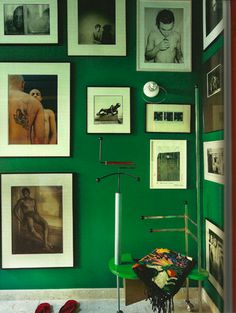 a room with green walls and pictures on the wall