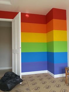 a room with a rainbow painted on the wall