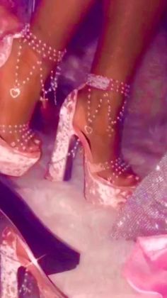 two pairs of high heeled shoes with pearls on them