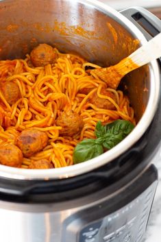 spaghetti and meatballs are being cooked in an instant pot