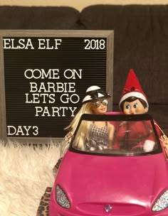 two dolls in a car with a sign that says fiesta elf come on barbie let's go party day 3