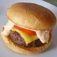 a hamburger with cheese and tomato on it