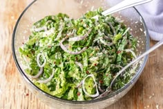 a glass bowl filled with salad and onions