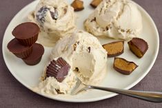 a plate that has some ice cream and chocolates on it with a spoon next to it