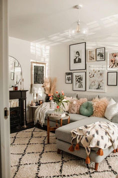 a living room filled with lots of furniture and pictures on the wall above it's couch