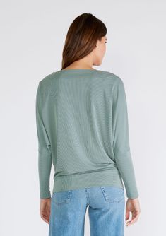 A simple and chic long-sleeved ribbed-knit pullover. Ribbed knit Relaxed fit Long tapered dolman sleeve Boat neckline Can be worn on or off the shoulder Lightweight pullover An elevated addition to your lounge wardrobe, our soft ribbed knit pullover is the perfect lightweight layer for running errands or warming up after a yoga class. With long dolman sleeves and a wide boat neckline that can be worn on or off the shoulder. Pairs effortlessly with leggings or jeans. Model is 5'9, wearing a size Wide Neck Top, Lounge Style, Warming Up, Boat Neckline, Knit Pullover, Yoga Class, Dolman Sleeve, Knitted Pullover, Running Errands