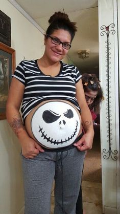 a pregnant woman wearing a jack skelling costume