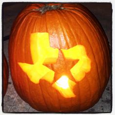 a carved pumpkin with the shape of a star on it's face and cutouts in the middle