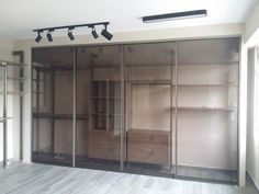 an empty room with sliding glass doors and shelves