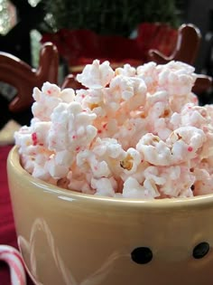 a bowl filled with white and red popcorn