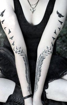 two women with tattoos on their arms and one has a bird tattoo on her arm