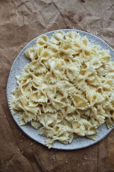 a white plate topped with macaroni and cheese on top of a piece of wax paper