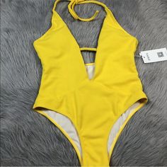 Up For Sale Is A Women’s Swimsuit By Zaful. Tagged A Size Us 6. New With Tag But There Is No Sanitary Liner. Yellow Ribbed Halter One Piece Swimsuit. Please Know How This Brand And Style Fits Before Purchasing. Returns Are Not Allowed For Fit Issues Especially On Swim. V-neck Stretch Bodysuit For Beach Party, V-neck One Piece For Spring And Summer, High Waist Bodysuit For Poolside Summer, Yellow Backless Bodysuit For Beachwear, Spring Halter Neck Beachwear One Piece, Summer High Waist Beachwear Bodysuit, High Waist Summer Beachwear Bodysuit, Summer High-waist Beachwear Bodysuit, High-waist Beachwear Bodysuit For Summer