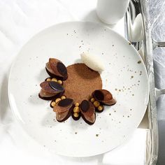 a white plate topped with food on top of a table