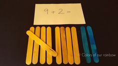 several popsicle sticks are next to a piece of paper