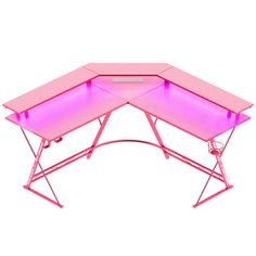 a pink computer desk with two laptops sitting on it's sides and the top half open