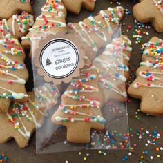 there are many decorated ginger cookies in the bag and on the table with sprinkles