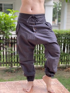 "Street Samurai Style Pants, Unique style Ninja pants are comfortable, Samurai Pants, Drop Crotch Pants are comfortable to wear. Handmade with a very lovely pattern, it is easy to wear and great for many occasions. Fashion Street Style Pants, Handmade Ethically, Breathable, Unisex, Comfortable to Wear MATERIAL: Cotton fabric SIZE: Size with Elastic waist and tied MEASUREMENT: Waist: 30\"- 40\" elastic & waist-tied Hip 46\" Waist to Gusset 19\" Inseam 28\" Ankle 10 -12\" Length: 41-43\" ❤ PAY Street Samurai, Street Style Pants, Cotton Gauze Pants, Samurai Style, Ninja Pants, Pants Unique, Yoga Harem Pants, Samurai Pants, Handmade Pants