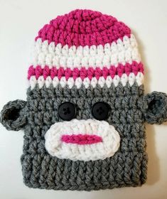 a crocheted hat with a monkey face on it