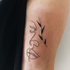 a woman's arm with a black and white tattoo design on the left side