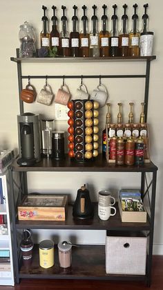 a shelf filled with lots of different types of condiments on top of it