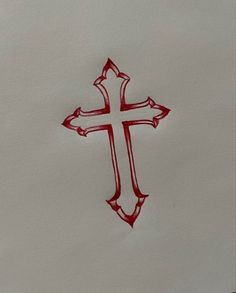 a cross drawn in red ink on white paper