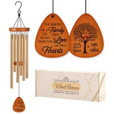 the wooden wind chime is next to its box and it's gift bag