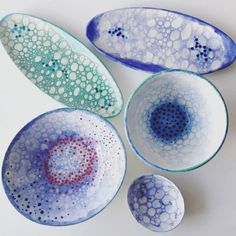 four blue and white bowls sitting next to each other