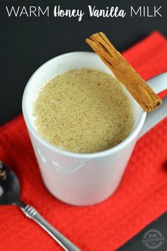 a cup of coffee with cinnamon sticks sticking out of it