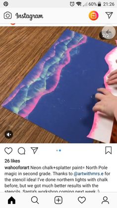 someone is making an art project with watercolor paper and glue on top of it