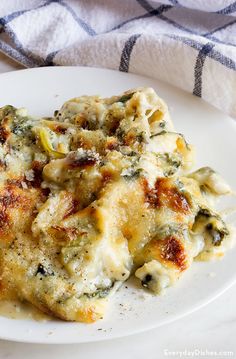 a close up of a plate of food with broccoli and cheese on it