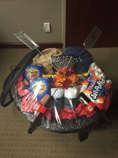 an assortment of items sitting on top of a round table in a room with carpeted flooring