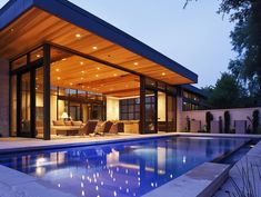 an outdoor pool area with a covered patio next to it