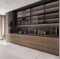 a modern kitchen with marble counter tops and stainless steel appliances on the wall, along with large windows