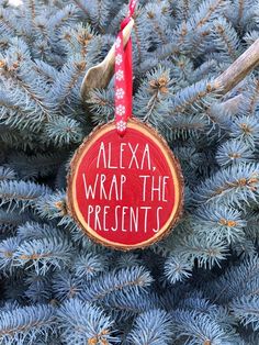 a christmas ornament that says, alexa wrap the presents hanging on a tree