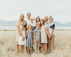 a family poses for a photo in an open field