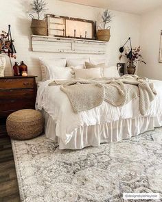 a white bed sitting in a bedroom on top of a rug