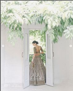 a woman is standing in an open doorway