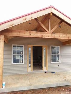 a house that is under construction with wood framing on the front and side of it