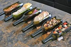 a table topped with lots of different types of food on top of metal tongs