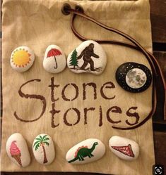 some rocks that are sitting on top of a wooden board with the words stone stories written on them